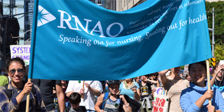RNAO members holding advocacy flag