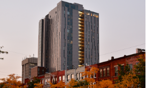 A city block with an apartment building in the fall