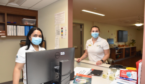 Nurses in mask at a workstation in a hospital