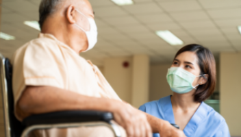 Nurse speaking with older adult