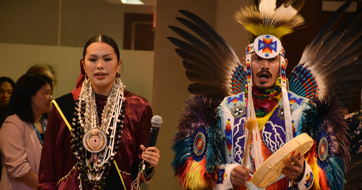 The Red Sky Performance Group officially open the AGM with an Indigenous song, leading the procession to their seats. 