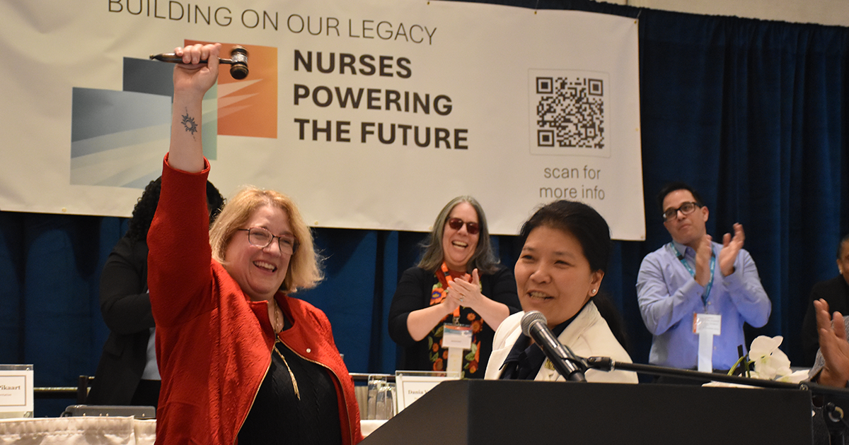 Incoming RNAO President Sue LeBeau (pictured front left) triumphantly clutches the official board gavel passed to her by (now) RNAO Past-President NP Lhamo Dolkar on May 29, 2026.  