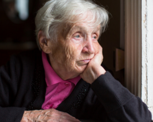 A senior woman looking out the window