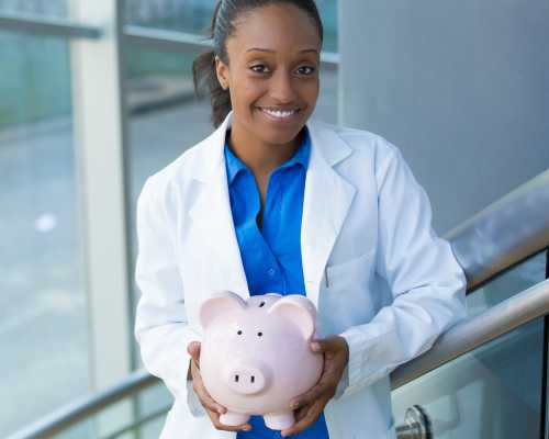 Medical professional with piggy bank