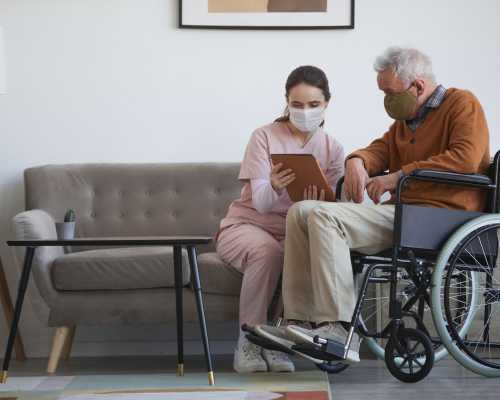 A nurse with a senior patient in a wheelchair